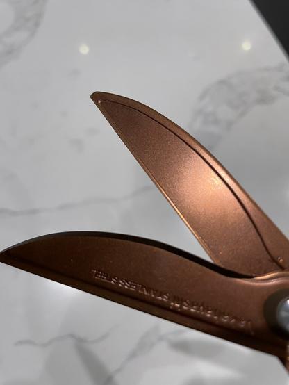 Splayed open scissors revealed scalloped blade interior