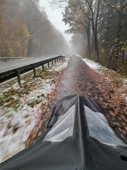 Point of view from a cargo bike on an empty bike path in winter mist