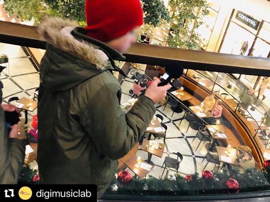 Child makes field recordings in a mall @ deeplistening workshop