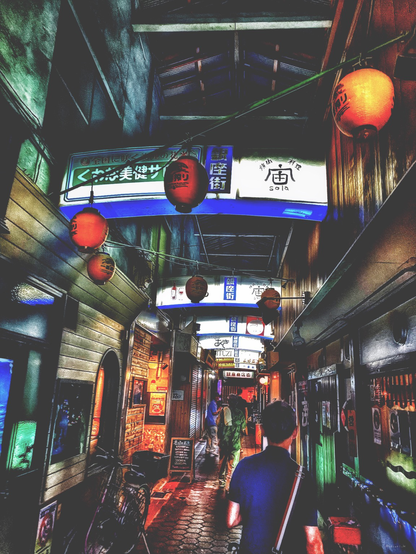 Narrow back street. Lots of bars on both side and red lanterns are hanging above