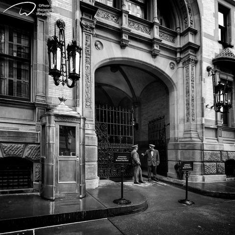 Entrance gate with porters from the Dakota building in New York opposite Central Park.