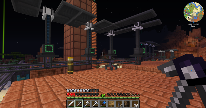 Screenshot from Minecraft. Shows a line of power cables attached to solar generators, running across the tops of buildings.