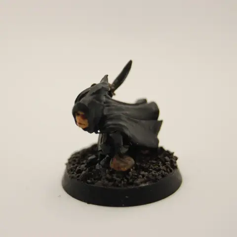 A hooded thief character crouched low to the ground, holding a knife and bag of loot