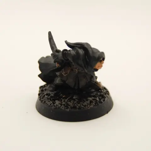 A hooded thief character crouched low to the ground, holding a knife and bag of loot