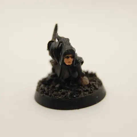 A hooded thief character crouched low to the ground, holding a knife and bag of loot