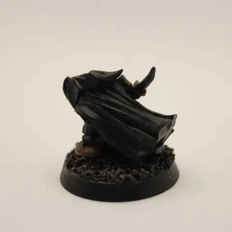 A hooded thief character crouched low to the ground, holding a knife and bag of loot