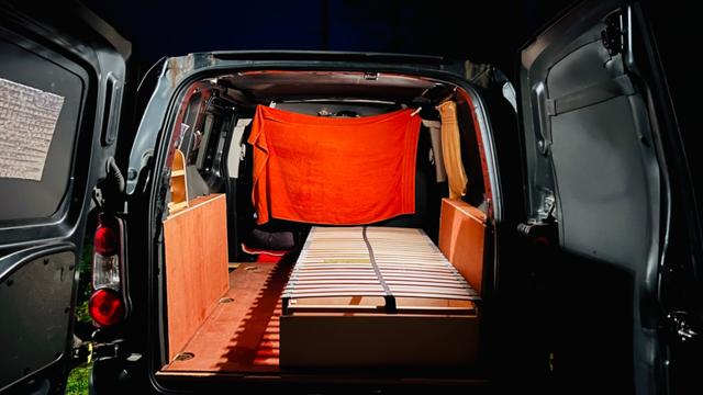The same van, with no tools etc in, with the base and slats of a single bed - the basis of a micro campervan