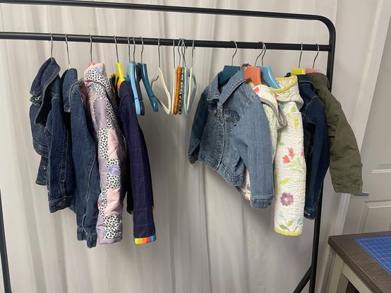 A coat rack showing several child-sized quilt coats
