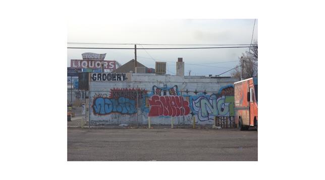 The original photo of a graffiti-covered liquor store.