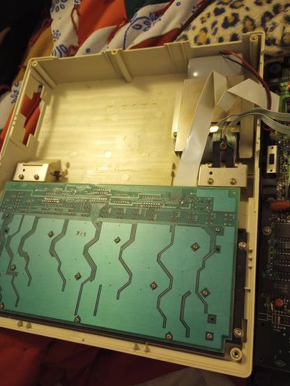 Insude the too of the case. Keyboard circuit board, battery pack, cables going to screen