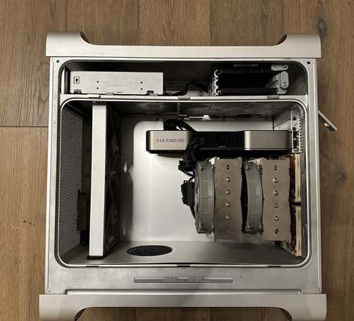 An opened Apple Power Mac G5 computer case, showing modern internals with an Intel i9 9900K processor and an Nvidia GeForce RTX 3080 GPU.