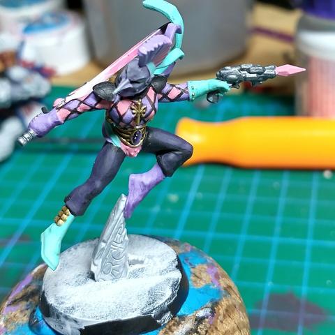 Partially painted miniature aeldari harlequin for Warhammer 40k, front view