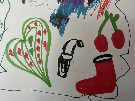 One the left a large green love heart with lots of little red love hearts inside it, in the middle a black and white drawing of an elf’s face with a hat on, and on the right a red boot or stocking with two red cherries above it