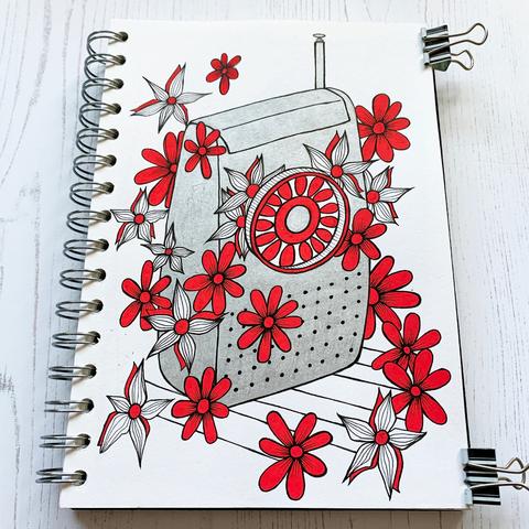 Stylised illustration of a 1970s transistor radio in silver with red flowers coming oud of the dial and surrounding the image. Fineliners and Posca pens in a A5 Seawhite of Brighton sketchbook, 2020.