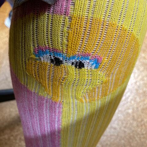 Pink and yellow compression socks with Big Bird’s face