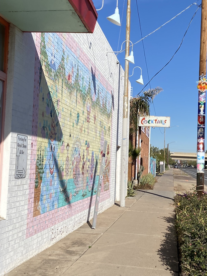 Mural on wall with faded cocktail sign