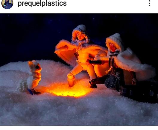 (All action figures) A wintry snowy scene of Padme Amidala and Ahsoka Tano warming themselves by a fire with a little furry creature.