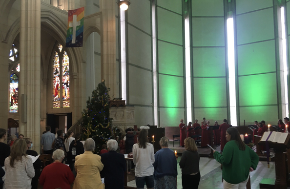 Choir and Congregation gathered around a newly decorated Christmas tree