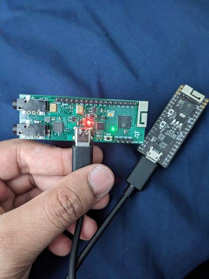 Green PCB board, the puca DSP in the foreground, and a black PCB, the ESP32 kit, in the background.