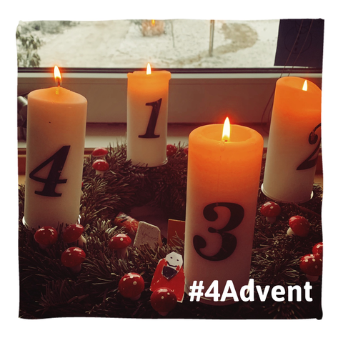 Vier Kerzen leuchten auf einem Adventskranz