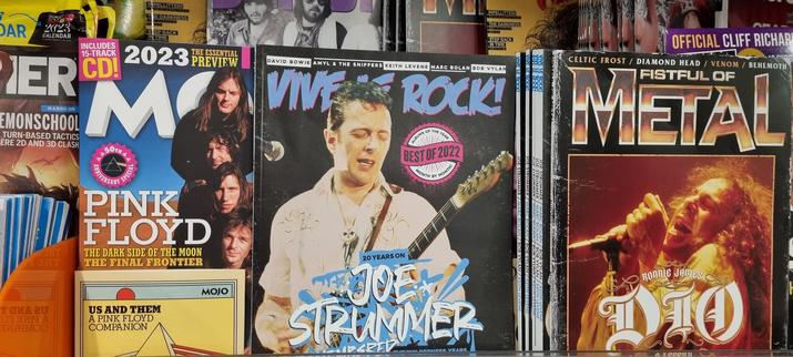Newsagent magazine rack. At the centre is Vive Le Rock, a UK punk, post-punk and indie monthly publication with Joe Strummer from The Clash on its front cover.