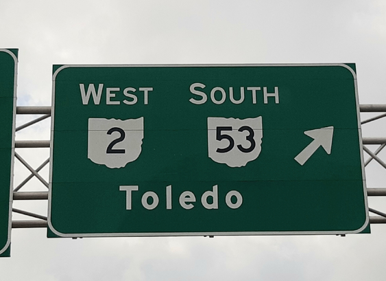 Highway sign for an exit that leads to Toledo.
