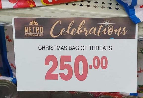 Metro Supermarket sign says 250 pesos for a "Christmas Bag of Threats" (instead of treats!)