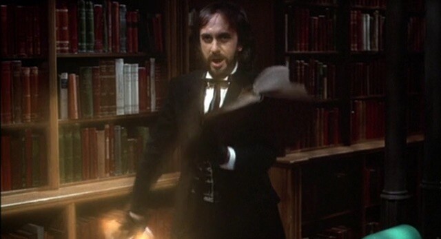 A black suit wearing evil man ripping and throwing pages out of a book.