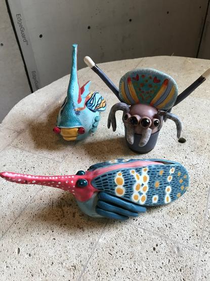 3 pottery pieces. One treehopper, one peacock spider, one membracid.