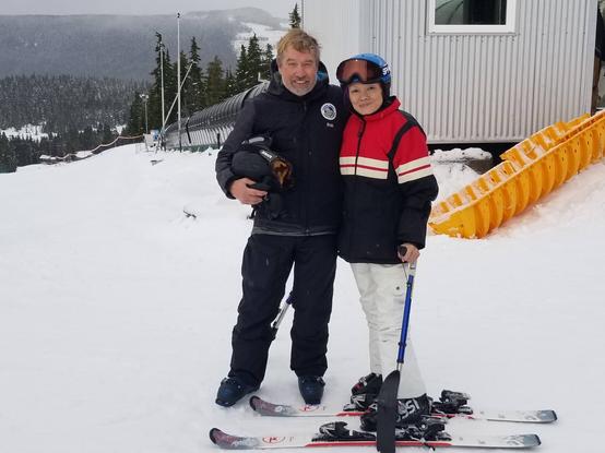 Me & my adaptive ski instructor, standing in snow at Mt. Washington.