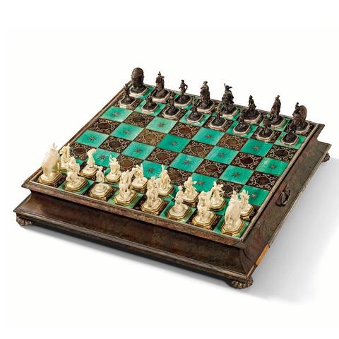 The bases of the chess pieces each stamped by the silversmith Paul Solanier (1635-1724). One of the ivory chess pieces indistinctly signed 'HE../M...'
The top of the chess board with alternating squares of stained ivory and tortoiseshell inlaid with silver stars and scrolls; the sides veneered with tortoiseshell and silver foil trim and fitted with two drawers to house the chess pieces; the chess pieces made of ivory on silver-gilt bases and from ebonised walnut (?) on ebony and silver bases; the pieces in the form of standing warriors, figures on elephants and figures on horseback
56.5 x 56.5 x 11.5 cm, the board; 8 cm high, the tallest chess piece.
PROVENANCE:
Probably Christian I von Münch (1690-1757) ennobled in 1731, then by direct descent to
Oscar von Münch (d.1920), whose property on his death passed to the present owner's family.