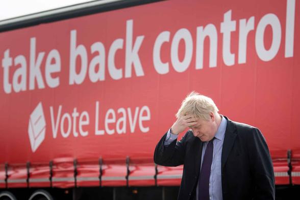 Curtain sided lorry with white lettering on red background bearing the words Take Back Control  with Vote Leave beneath. In front is Johnson with his right hand on his forhead as he looks downwards with chin resting on his tie knot, looking  theatrically concerned