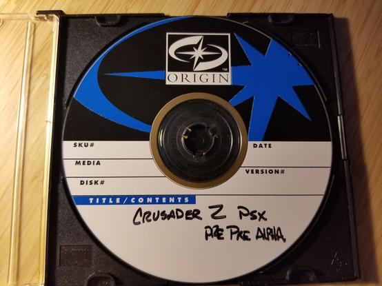 A photograph of an origin systems cd-rom that reads Crusader 2 PSX Pre-Pre Alpha