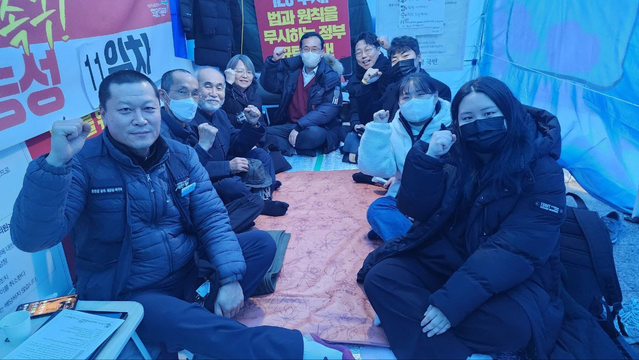 The same truckers, students, activists are still sitting cross legged on the floor, but now they face the camera with smiles on their faces and fists raised in defiance.
Fuck the president :)