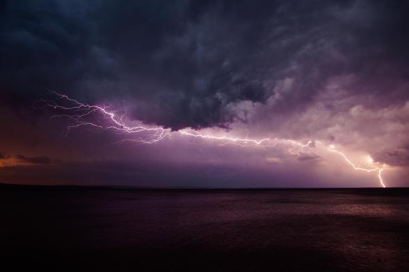 Slow shutter speed photo of a lightning bolt over Lake Superior.