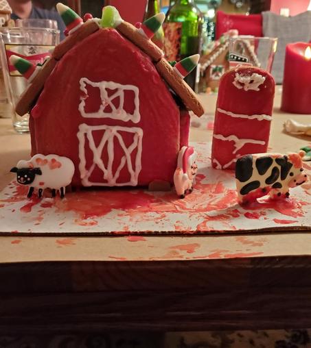 Gingerbread barn covered in red icing that looks like blood.