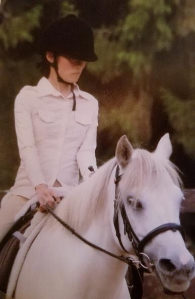 At paraequestrian training camp with Paralympics coach.  Riding Angel, a pure white quarter & Arabian cross horse.