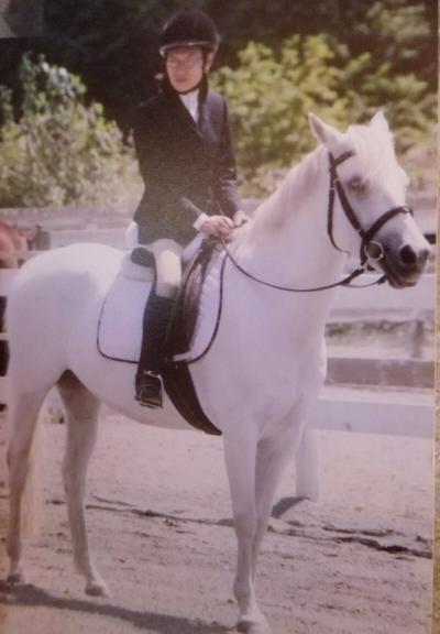 At BC Games, in Powell River, in the dressage ring.  Riding Angel, a pure white quarter & Arabian cross horse. We are both in full English dressage competition ready attire.