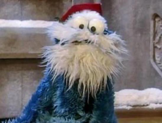 Cookie Monster dressed up as Santa Claus