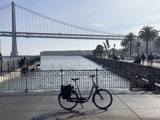 My ebike in front of the little inlet by Pier 14 in San Francisco with the bay bridge in the background. Facing south.