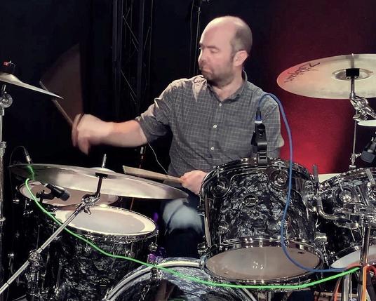David Payne playing the drums.