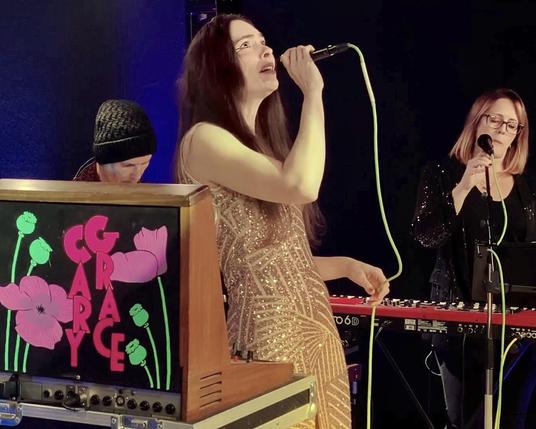 Cary Grace and Victoria Reyes singing on stage.