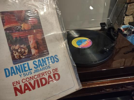 Album cover for Daniel Santos y sus Jibaros "En Concierto de Navidad".  Turntable playing LP in background.