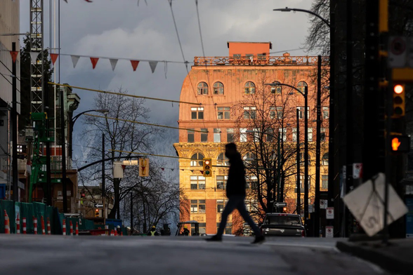Man walking across the street in Vancouver