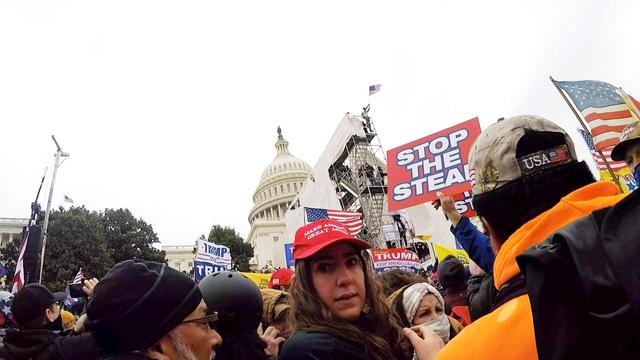 A video still showing a woman who I believe to be Chaya Raichik wearing a MAGA hat on the NW lawn of the US Capitol on Jan 6