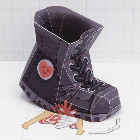A photo of a papercraft boot crushing a cherub