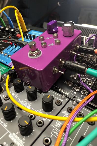 francois's purple ring pedal atop a modular synth - case is a nice purple color, with chrome switches and knobs