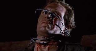 Man with barbed wire wrapped around his head and neck.