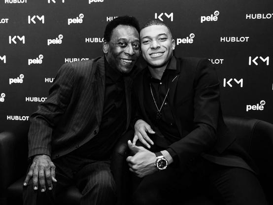 Picture of Pelé on the left side of the picture with Mbappe on with faves /cheeks together the right side of the picture