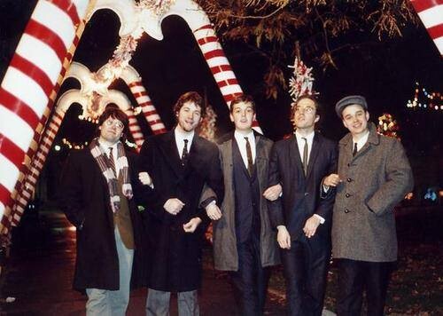 The Sleestacks in their Christmas finery standing under giant candy canes in Kalamazoo, Michigan.